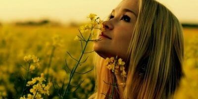 woman smelling flowers - mindfulness exercises adults 