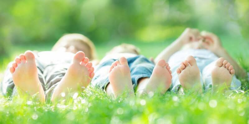 kinds laying in grass - Mindfulness Activities for Children And Teens